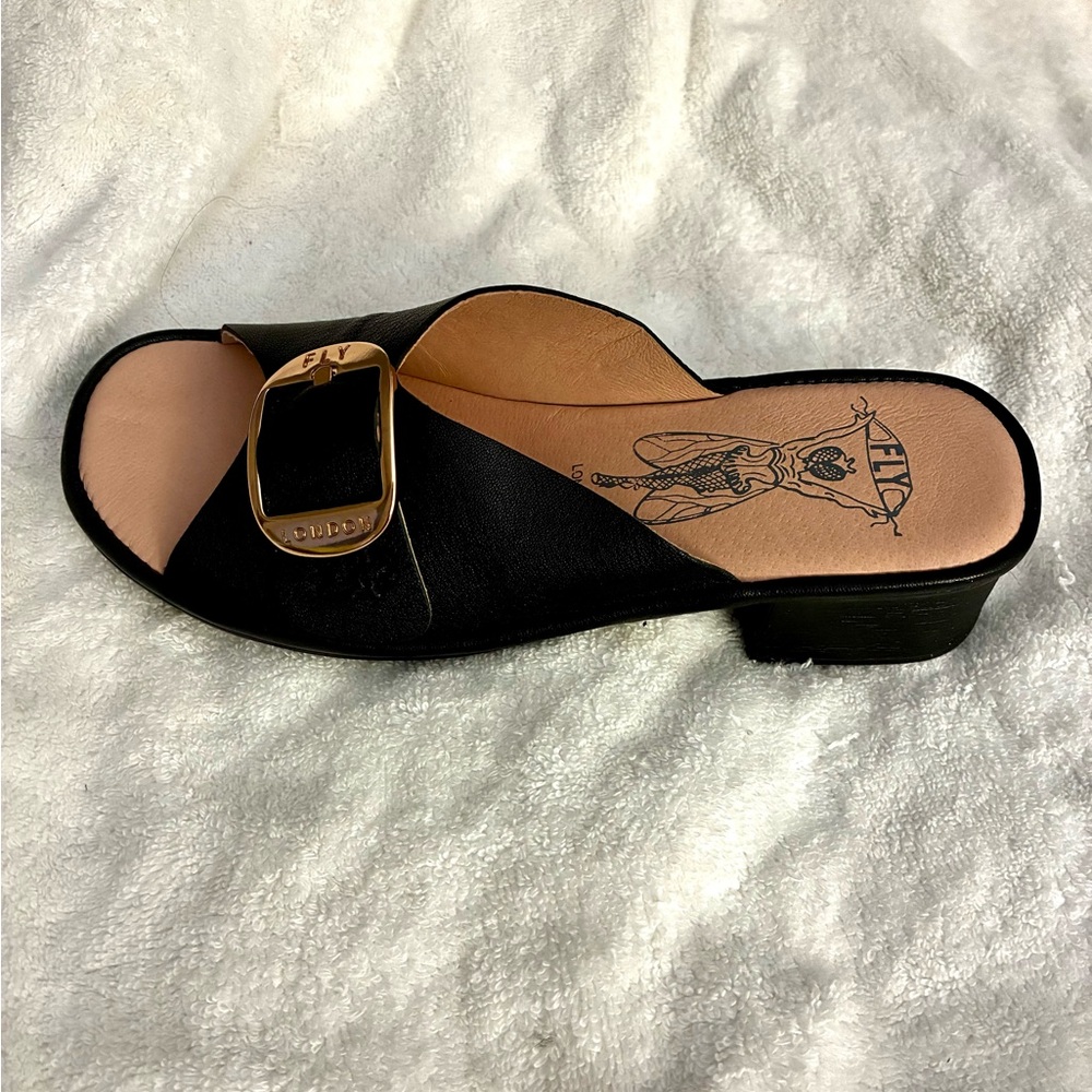NEW Fly London black leather slides.